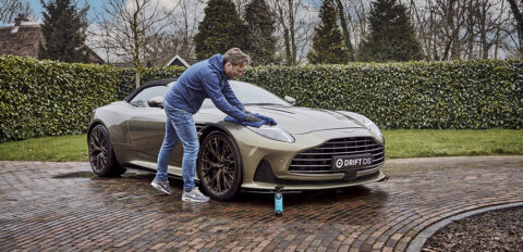 Man applying ceramic wax on Aston Martin DB12 Volante.